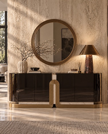Abode Home occasional — dark lacquered sideboard with round brass mirror on a travertine wall