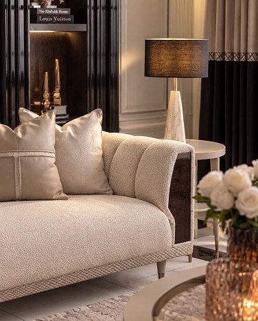 Abode Home upholstery — cream boucle sofa with satin pillows in a classic living room